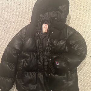 XS Champion brand faux leather and wool puffer jacket in black.